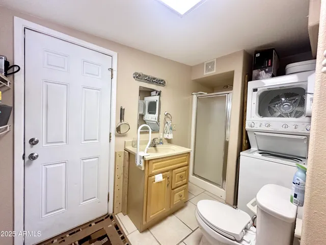 a white toilet sitting next to a bathroom sink and tub