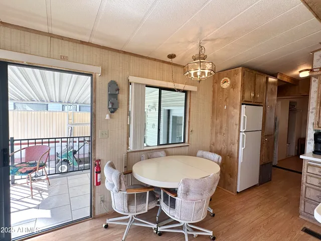 a living room with furniture a ceiling fan and a window