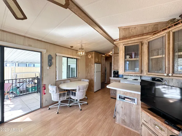 a kitchen with a stove a refrigerator and a fireplace