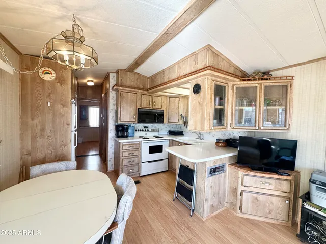 a living room with furniture a flat screen tv and floor to ceiling window