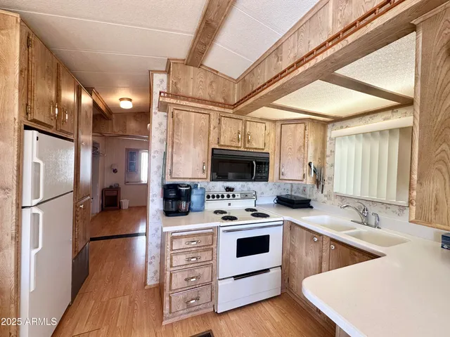 a kitchen with stainless steel appliances a stove microwave and refrigerator