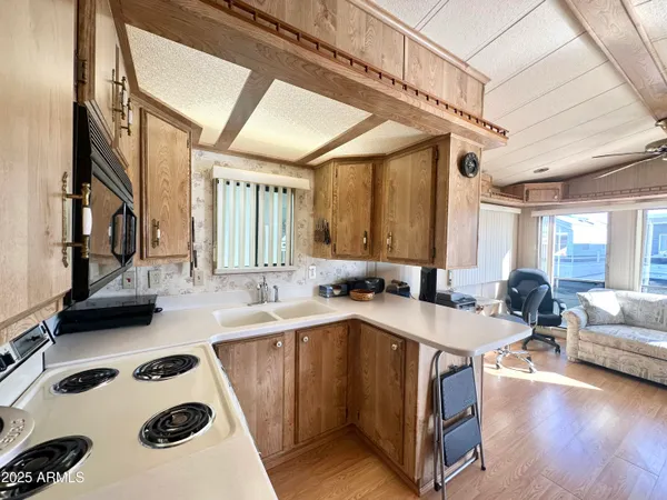 a large white kitchen with sink and window