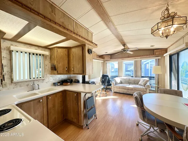 a view of a refrigerator in kitchen and wooden floor