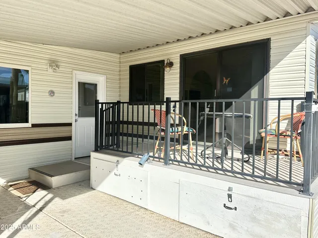 a view of a balcony with a floor to ceiling window and stairs