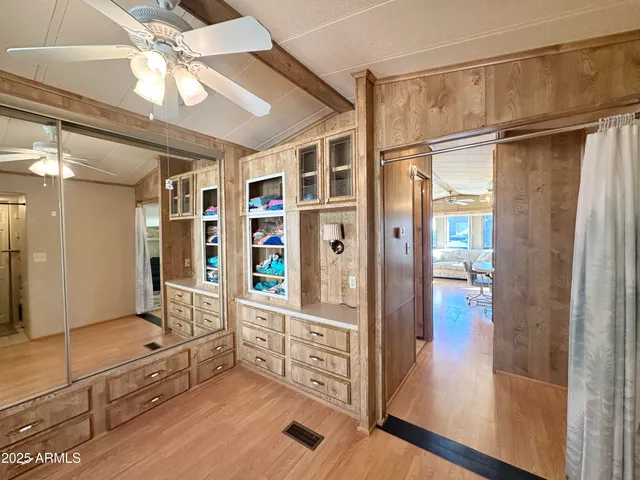 a view of an entryway with wooden floor and cabinet