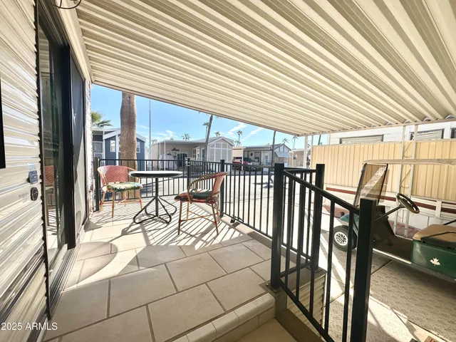 a view of a patio with a table chairs and backyard