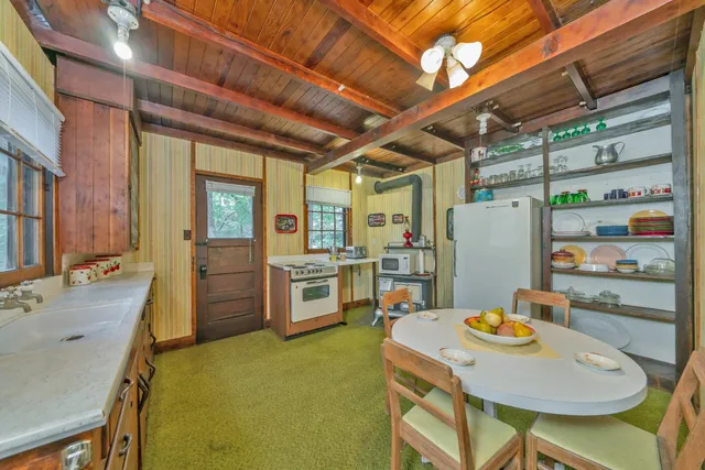 a kitchen that has a table and chairs in it