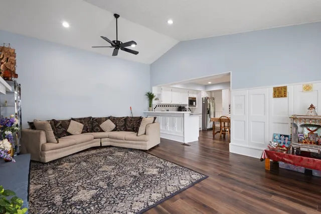 a living room with furniture and a chandelier