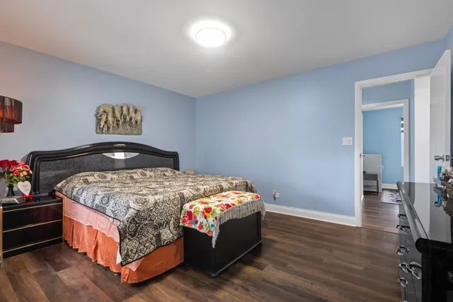 a bed sitting in a bedroom next to a window