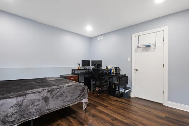 a bedroom with a bed and a desk