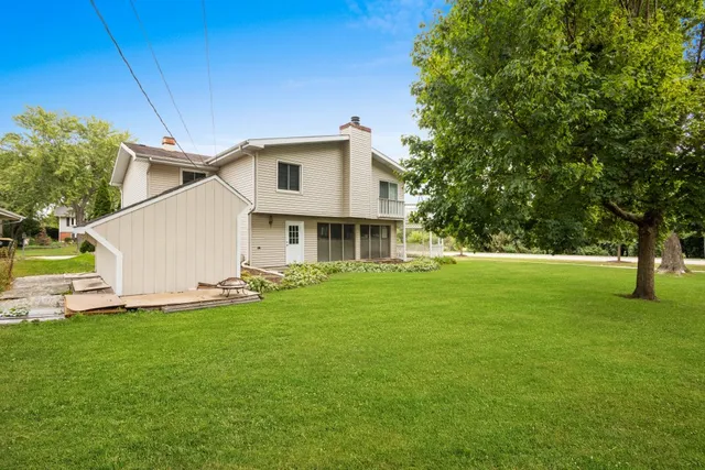 a front view of house with yard and trees