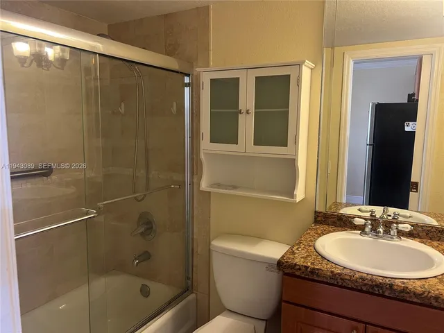 a view of a house with a backyard and trees