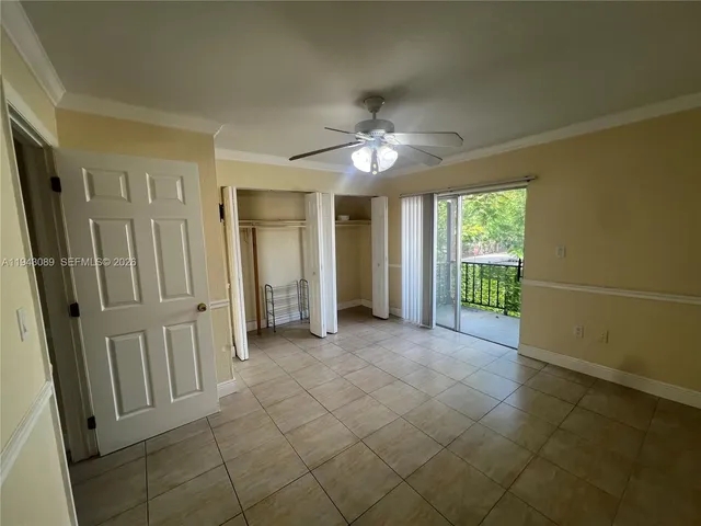 a kitchen with granite countertop a refrigerator a sink and wooden floor