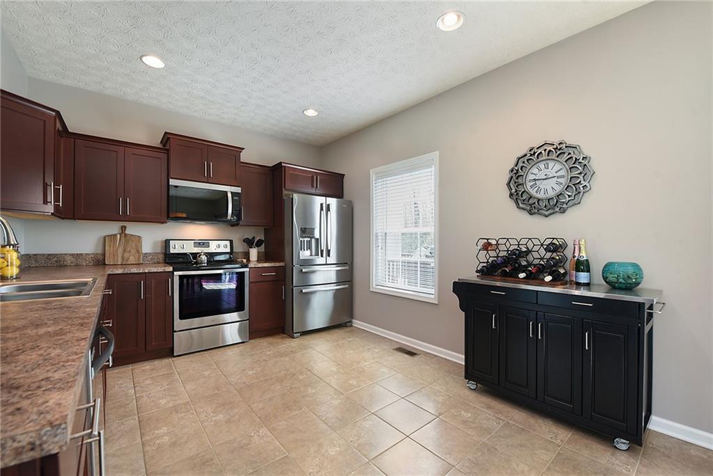 703 Freedom Drive Pittsburgh, PA 15205 - Photo 11 of 42 a kitchen with granite countertop a stove top oven and refrigerator