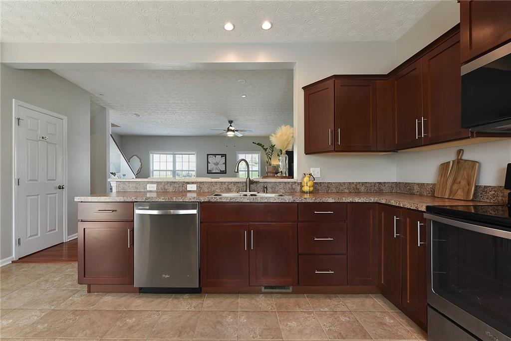 703 Freedom Drive Pittsburgh, PA 15205 - Photo 13 of 42 a kitchen with stainless steel appliances granite countertop a sink and a stove