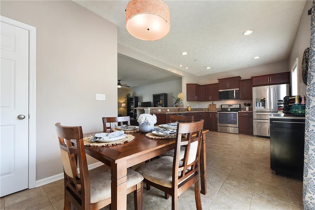 703 Freedom Drive Pittsburgh, PA 15205 - Photo 15 of 42 a dining room with kitchen island a table and chairs