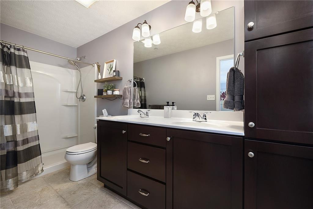 703 Freedom Drive Pittsburgh, PA 15205 - Photo 25 of 42 a bathroom with a double vanity sink toilet and shower