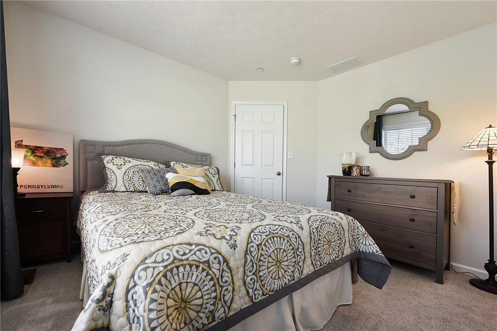 703 Freedom Drive Pittsburgh, PA 15205 - Photo 27 of 42 a bedroom with a bed and a mirror on dresser