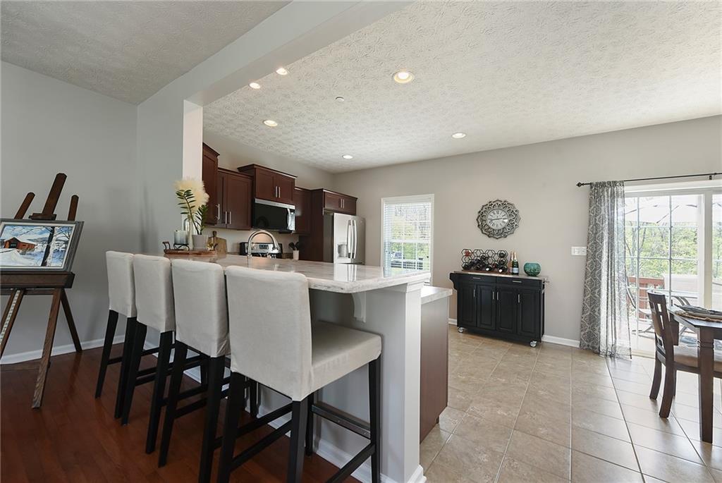 703 Freedom Drive Pittsburgh, PA 15205 - Photo 7 of 42 a living room with furniture a dining table and chairs with kitchen island