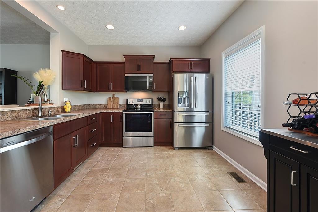 703 Freedom Drive Pittsburgh, PA 15205 - Photo 10 of 42 a kitchen with stainless steel appliances granite countertop a refrigerator stove a sink dishwasher and microwave