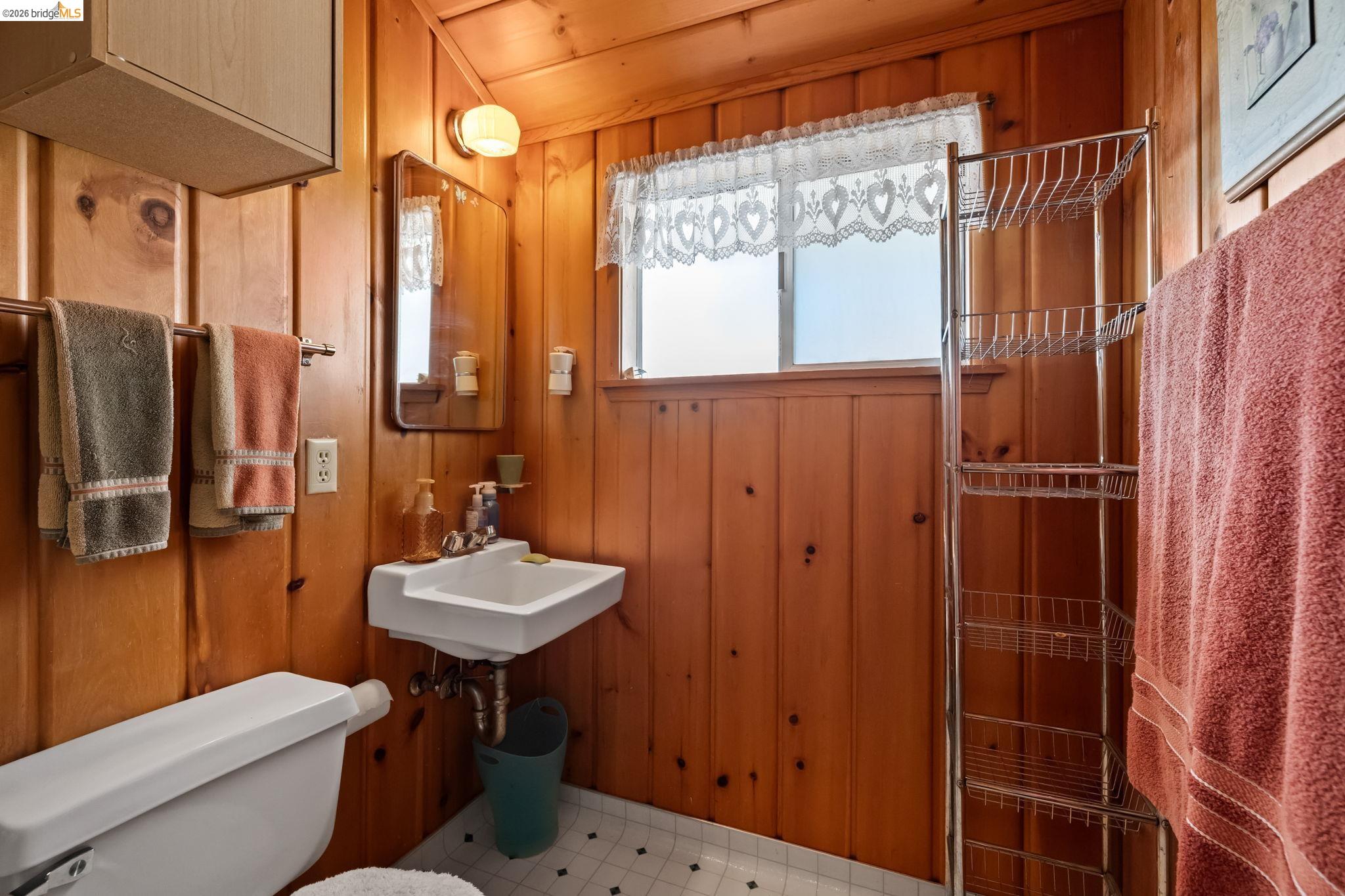 26039 Long Barn Road Long Barn, CA 95335 - Photo 22 of 27 Bathroom with wooden walls, a shower with door, wood ceiling, and light floors