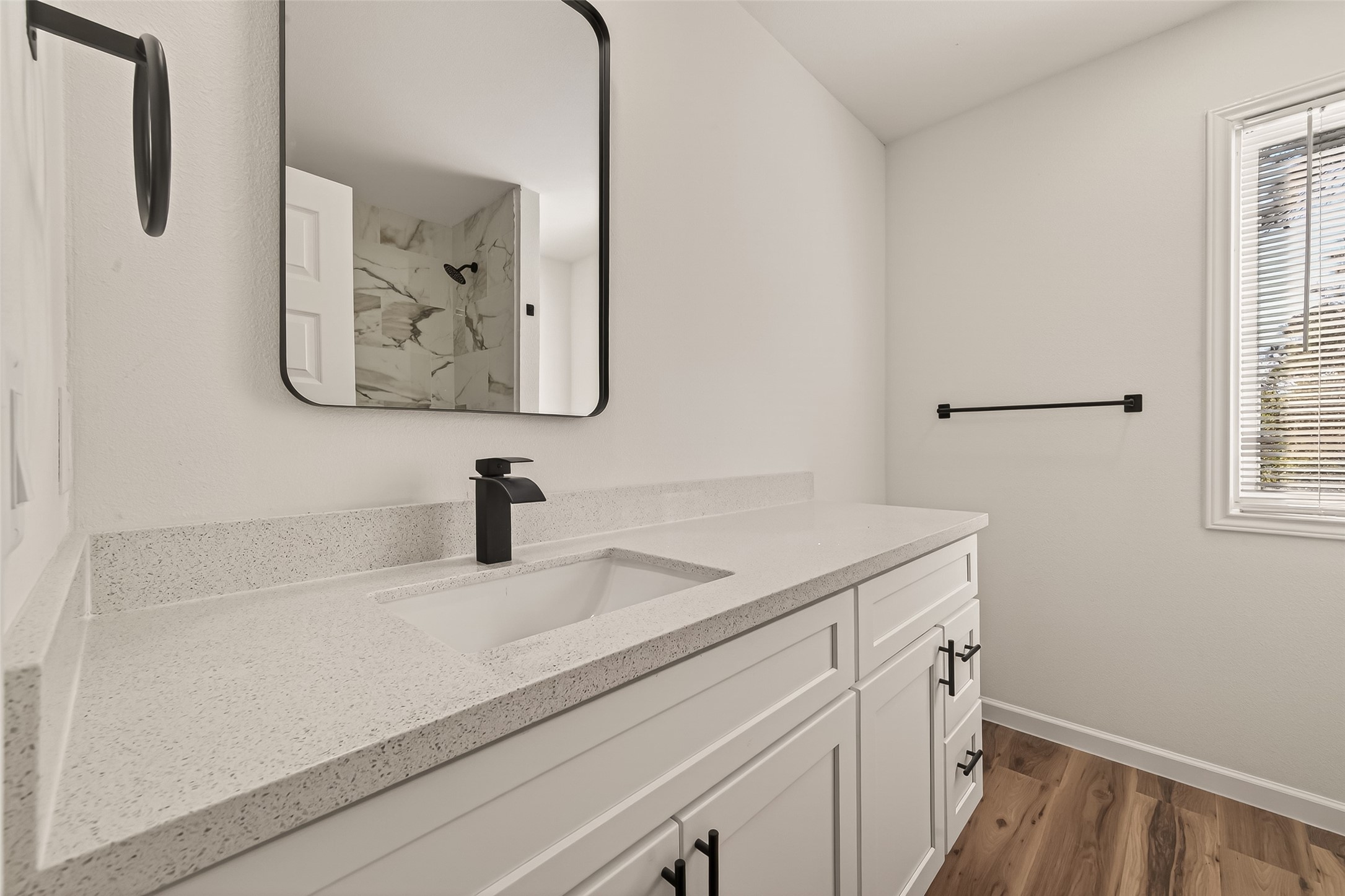 2915 Whispering Springs Drive Spring, TX 77373 - Photo 23 of 36 Modern vanity featuring quartz countertops, matte black fixtures, and sleek contemporary finishes.