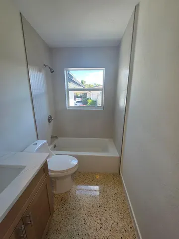 a bathroom with a sink a bathtub and a toilet