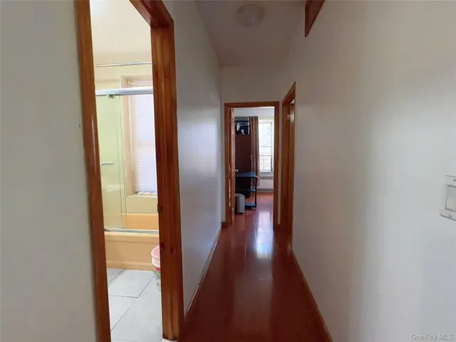 a view of a hallway with wooden floor