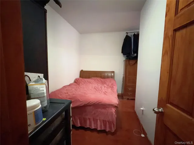 a bedroom with a bed and a mirror