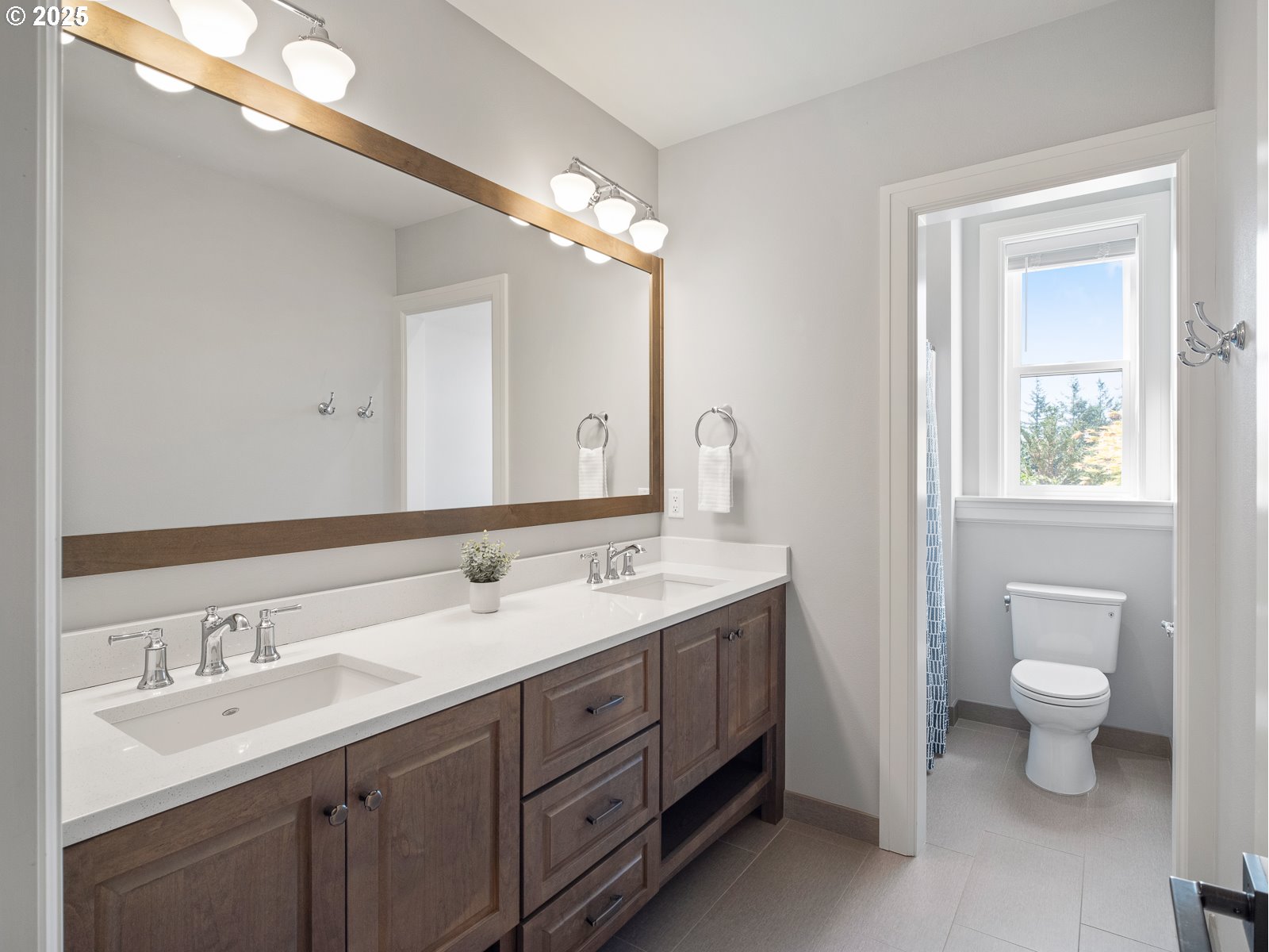 13848 Southeast Diamond Rdg Road Happy Valley, OR 97086 - Photo 28 of 48 a spacious bathroom with a double vanity sink a toilet and a mirror
