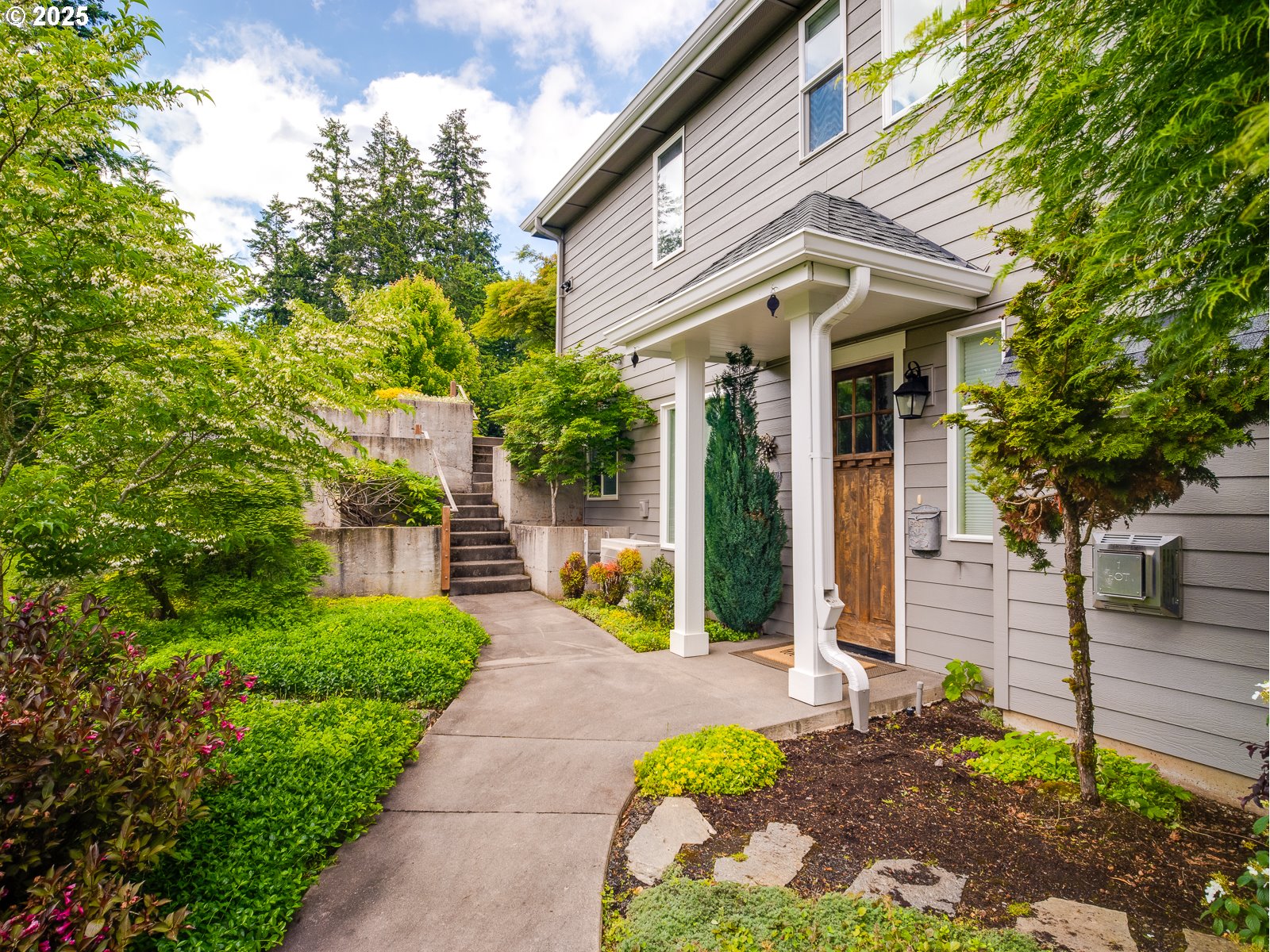 13848 Southeast Diamond Rdg Road Happy Valley, OR 97086 - Photo 32 of 48 a view of a house with potted plants and a bench