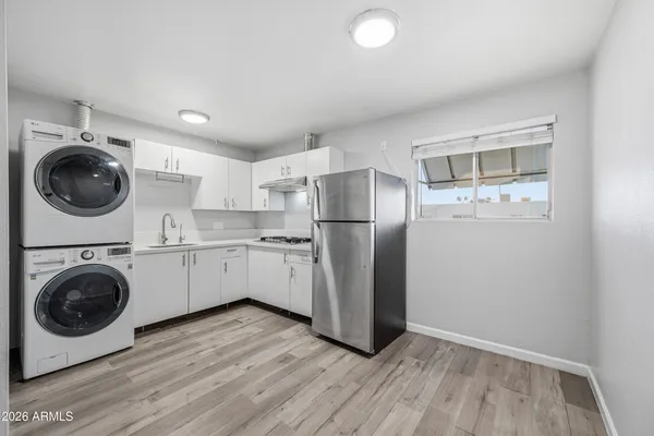 a utility room with sink dryer and washer