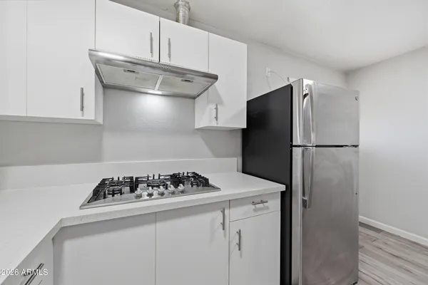 a kitchen with a refrigerator and a stove