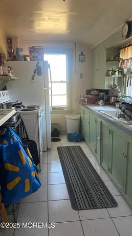 a kitchen with a cabinets and wooden floor