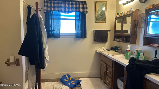 a bathroom with a sink toilet and a mirror