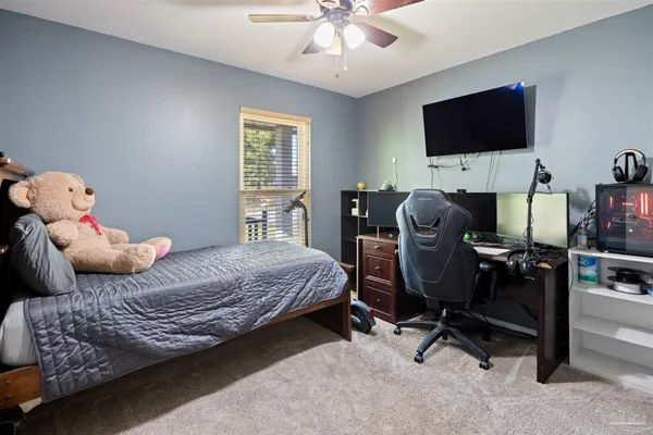 a work room with furniture and a flat screen tv