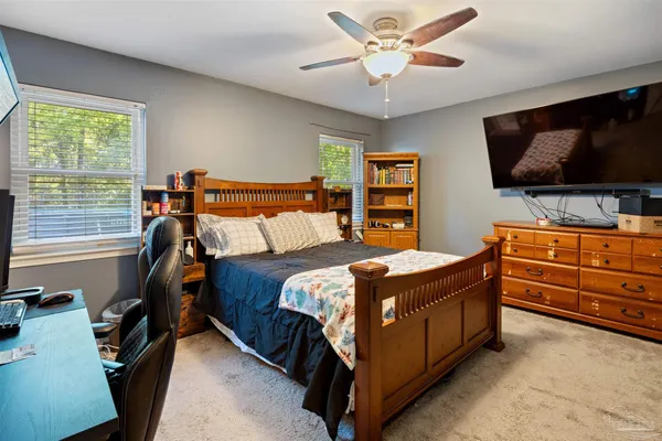 a bedroom that has a bed and a television