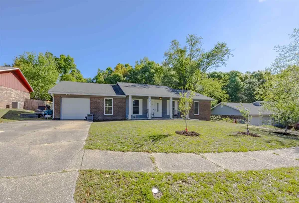 a house that has a tree in front of it