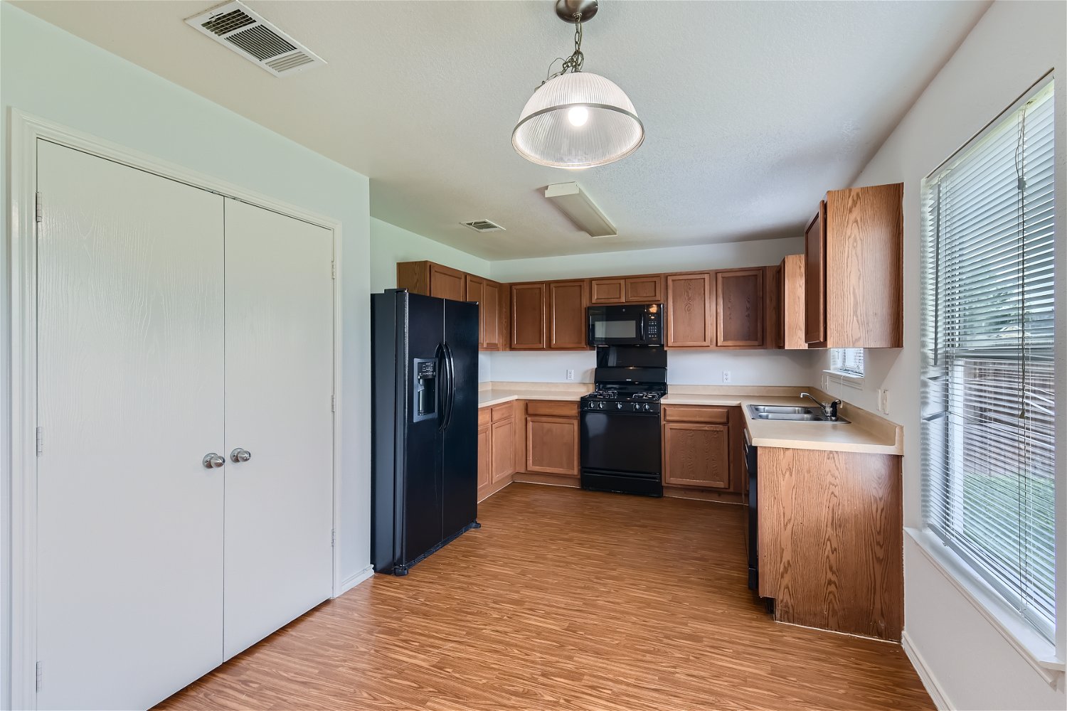 18408 Cloudmore Lane Elgin, TX 78621 - Photo 2 of 11 Functional kitchen with ample cabinetry and all essential appliances for daily living.