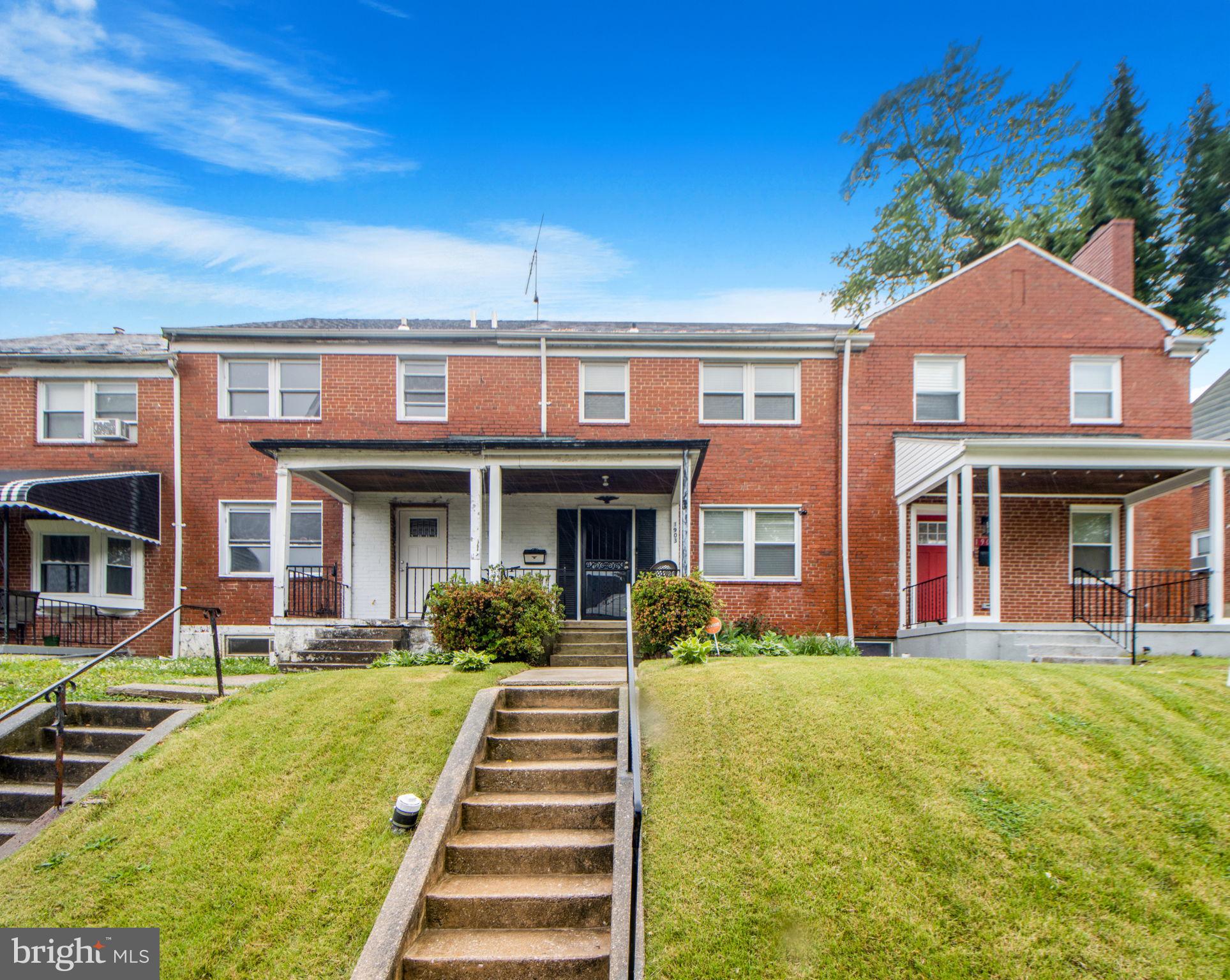 1903 Heathfield Road Baltimore, MD 21239 - Photo 1 of 30 a front view of a brick building with a yard