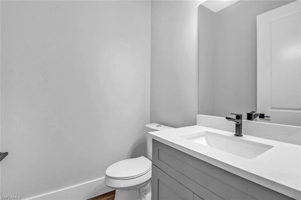 733 15th Street Southwest Naples, FL 34117 - Photo 15 of 34 a bathroom with a sink a toilet and mirror