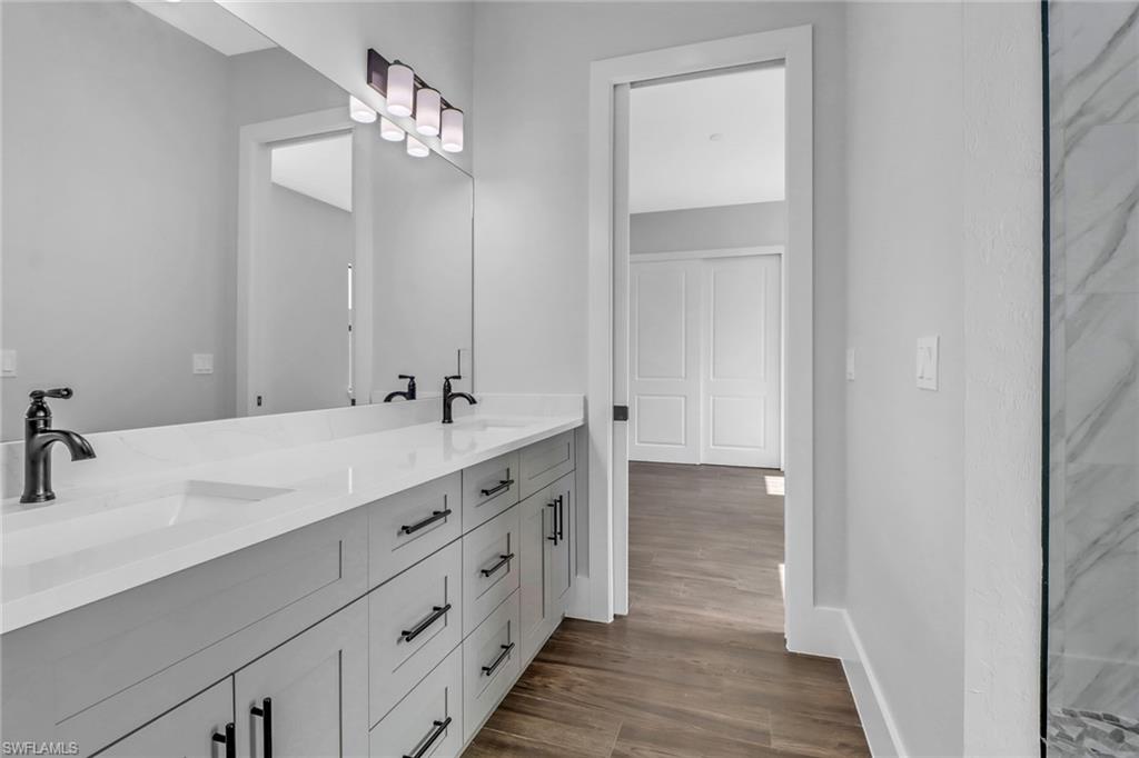 733 15th Street Southwest Naples, FL 34117 - Photo 24 of 34 a bathroom with a double vanity sink and a mirror