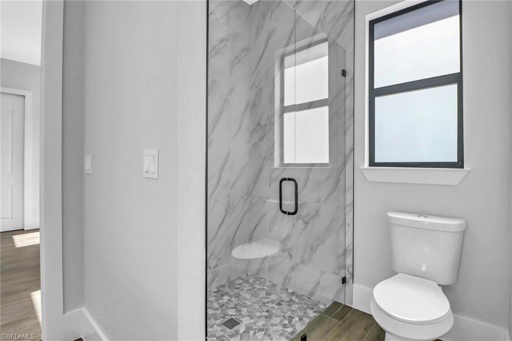 733 15th Street Southwest Naples, FL 34117 - Photo 25 of 34 a white toilet sitting next to a bathroom sink