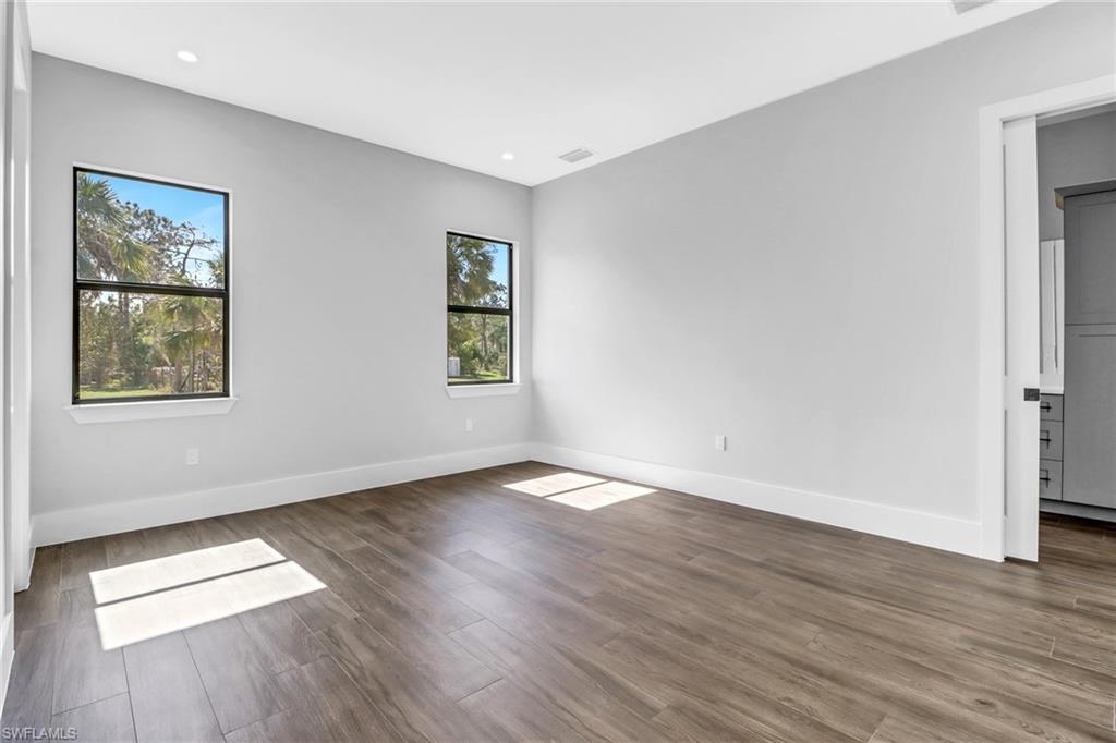 733 15th Street Southwest Naples, FL 34117 - Photo 26 of 34 a view of an empty room with wooden floor and a window