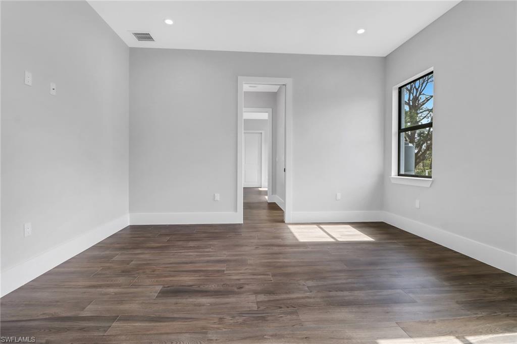 733 15th Street Southwest Naples, FL 34117 - Photo 30 of 34 a view of an empty room with wooden floor and a window