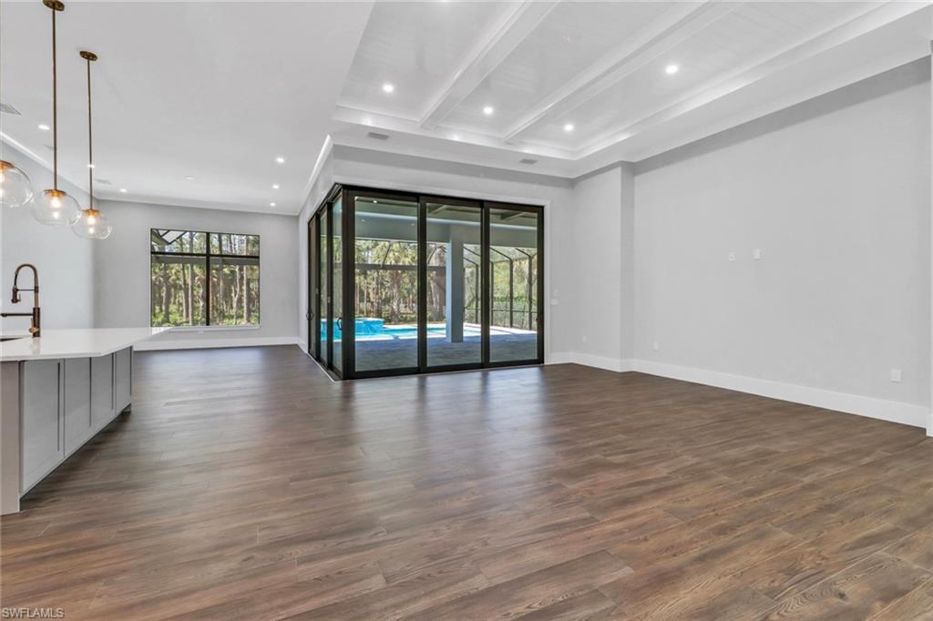 733 15th Street Southwest Naples, FL 34117 - Photo 5 of 34 a view of an empty room with wooden floor and a window