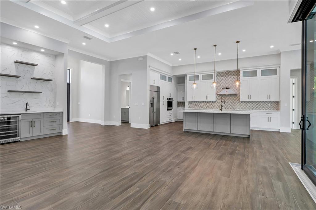 733 15th Street Southwest Naples, FL 34117 - Photo 7 of 34 a large kitchen with stainless steel appliances kitchen island a large counter top and a sink