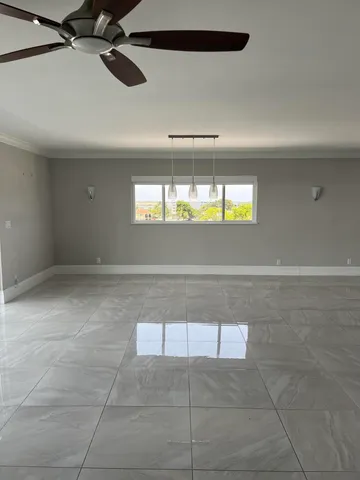 a kitchen with stainless steel appliances granite countertop a sink refrigerator and cabinets