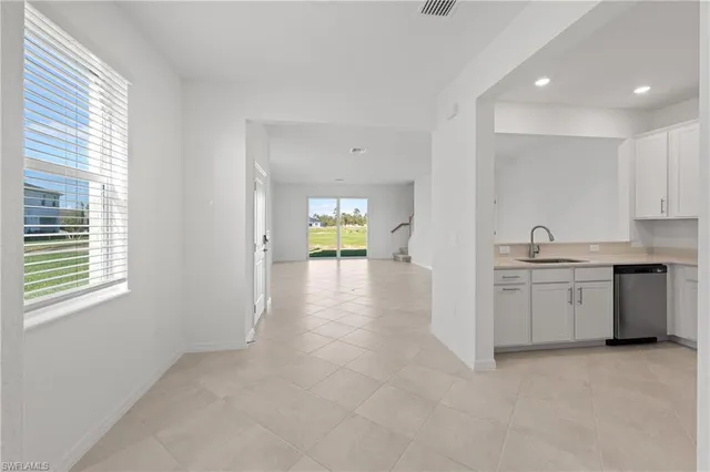 a view of a kitchen with a sink and a window