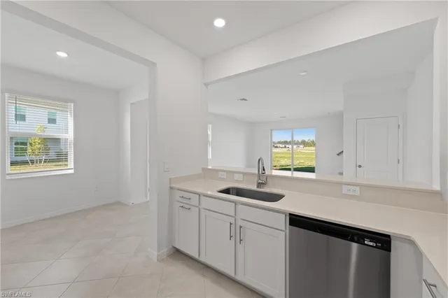 a kitchen with sink cabinets and window